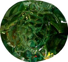 a green glass plate with a turtle on it