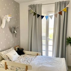 a bed room with a neatly made bed and curtains