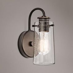 a wall light with a glass shade on it