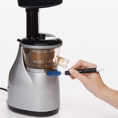 a person is using a juicer to make something