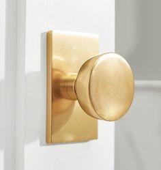 a close up of a door knob on a white door with a gold handle and round knob