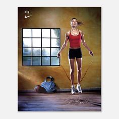 a woman jumping with a jump rope in front of a window and an exercise bag