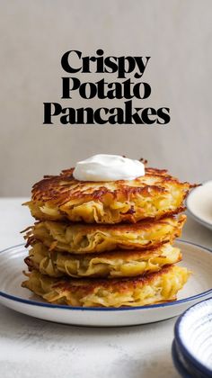 crispy potato pancakes on a white plate with sour cream and text overlay that reads crispy potato pancakes