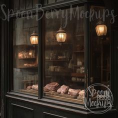 an old fashioned bakery window with pastries in the display case and light bulbs above it