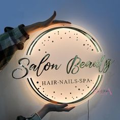 a person holding a sign that says salon beauty