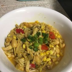 a white bowl filled with soup and vegetables