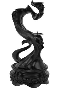 a black candle holder with two candles in the shape of a woman's head