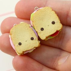 two tiny sandwiches are sitting in the palm of someone's hand, one has eyes on it