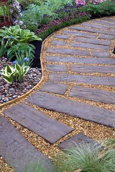 a stone path in the middle of a garden