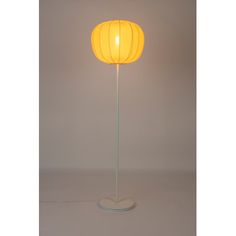 a yellow floor lamp with a white base