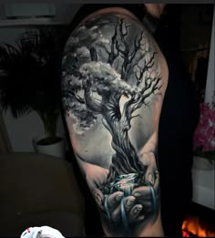 a man's arm with a tree on it