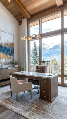 a home office with large windows overlooking the mountains