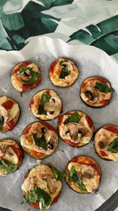 mini pizzas with mushrooms and spinach on top