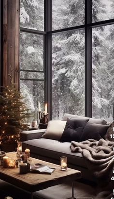 a living room filled with furniture and a christmas tree in front of a large window