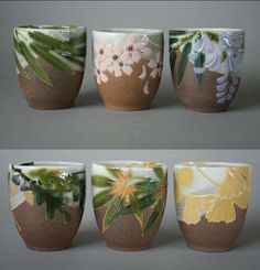 four different types of cups with flowers painted on the inside one is brown, white and green