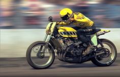 a man riding on the back of a yellow motorcycle