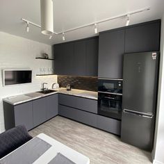 a kitchen with gray cabinets and white walls