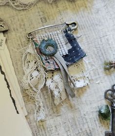 an altered piece of fabric with scissors and other items around it on top of a table