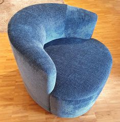 a blue chair sitting on top of a hard wood floor