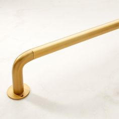 a gold colored metal handle on a white surface