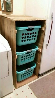 three baskets are stacked on top of each other in front of a washer and dryer