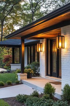 a white brick house with black trim and lights