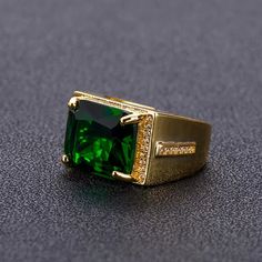 Stop the show with this beautiful cocktail ring. Stainless steel ring with 24K gold plating, set with a large green zircon stone. Adjustable, One Size Fits All Stone Rings For Men, Green Diamond Rings, Mens Ring Designs, May Birthstone Rings, Men Rings, Mens Gold Jewelry, Green Stone Rings, Engagement Rings Affordable, Men's Wedding Ring