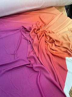 the bed is made up with different colored sheets