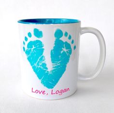 a coffee mug with a hand and foot imprint on the side that says love, logar