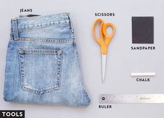 a pair of jeans, scissors and ruler on a white surface with text describing the parts of a jean