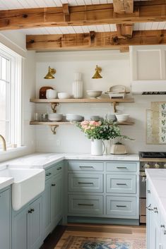 a kitchen with blue cabinets and white counter tops