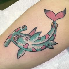 a tattoo on the arm of a woman with a fish and a whale in it