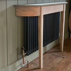 an old radiator in the corner of a room next to a wooden table