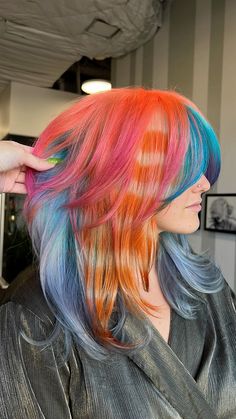 Blue laveder hair with neon orange into neon pink, one section is an orange racoon tail Orange And Blue Hair Ideas, Pink To Orange Hair, Pink Racoon Tail Hair, Orange Blue Hair, Racoon Stripes Hair, Orange And Blue Hair, Blue And Orange Hair, Orange And Pink Hair, Racoon Tail Hair