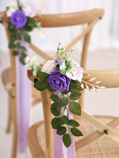 purple and white flowers are tied to the back of a chair