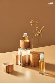 three wooden containers with flowers in them on a brown surface next to two small boxes