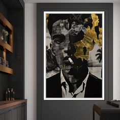 a black and gold painting on the wall next to a fireplace in a living room