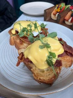 two pieces of bread topped with cheese and bacon