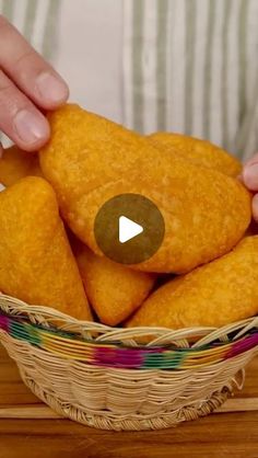 a person holding a basket filled with fried food