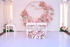 a wedding stage with flowers and chairs