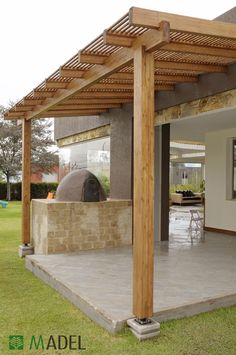 an outdoor living area with stone and wood pergolan, patio furniture and dining table