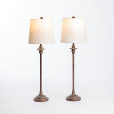 two lamps are sitting side by side on a white surface