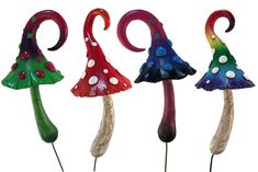 four different colored glass mushrooms on top of each other in the shape of umbrellas