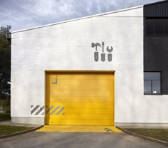 a yellow garage door in front of a white building