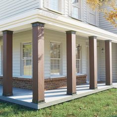 the front porch of a white house with columns