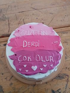 a cake that has been decorated with pink and red icing