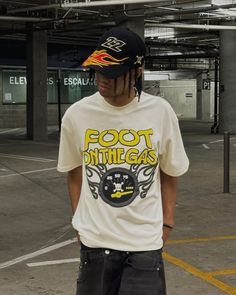 a young man standing on top of a skateboard in an empty parking garage area