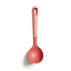 a pink spoon sitting on top of a white table