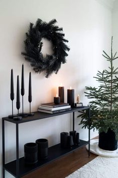 a christmas tree and some candles on a shelf