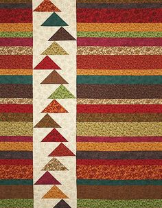 a multicolored striped area rug with an arrow design